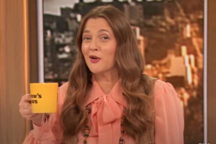 Drew Barrymore holding yellow cup