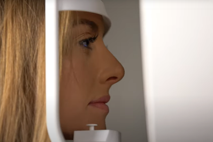 Woman looking into a vision machine