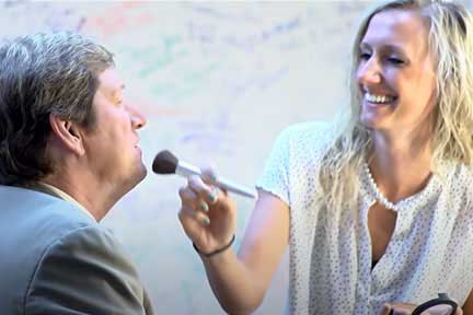 Makeup artist applying treatment to mature gentleman