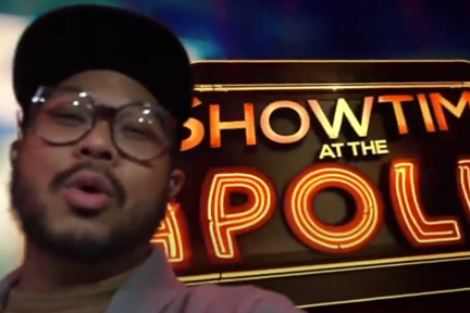 Young man in front of Apollo sign