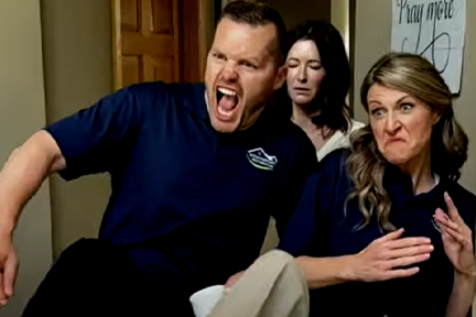 Man in blue t-shirt kicking attackers